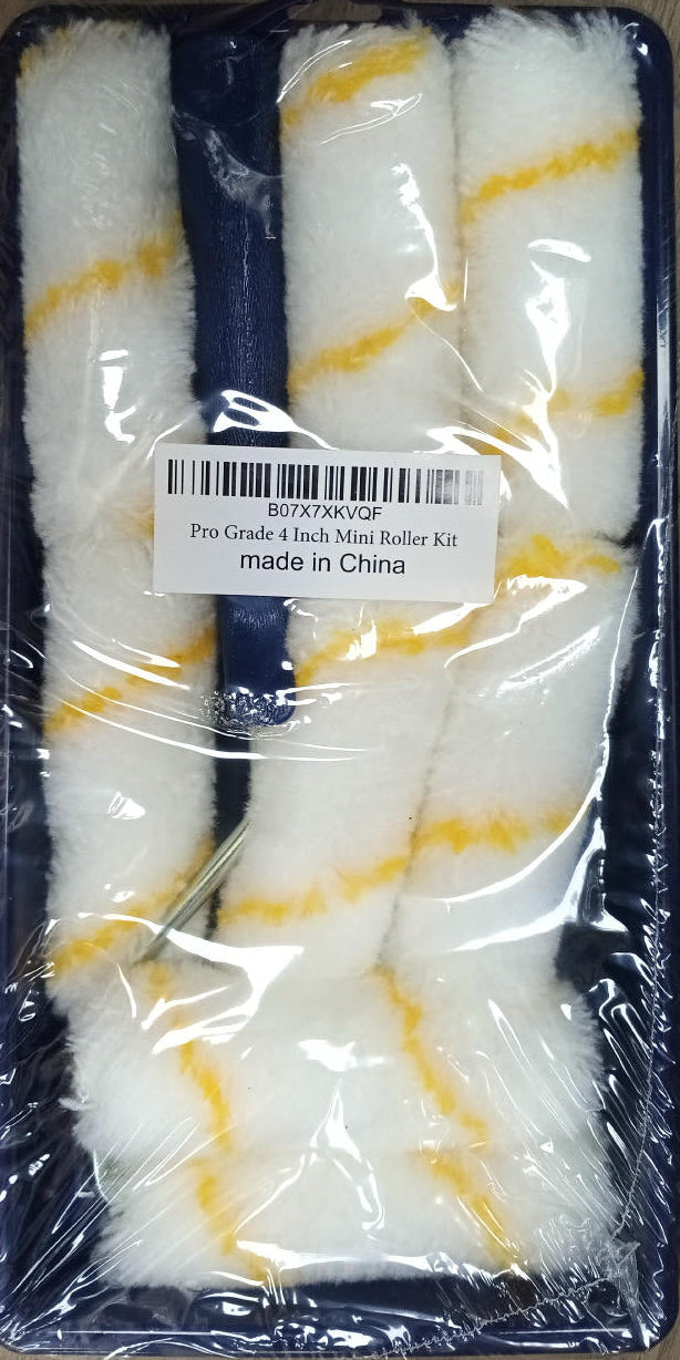 Set of paint rollers in packaging on a wooden surface