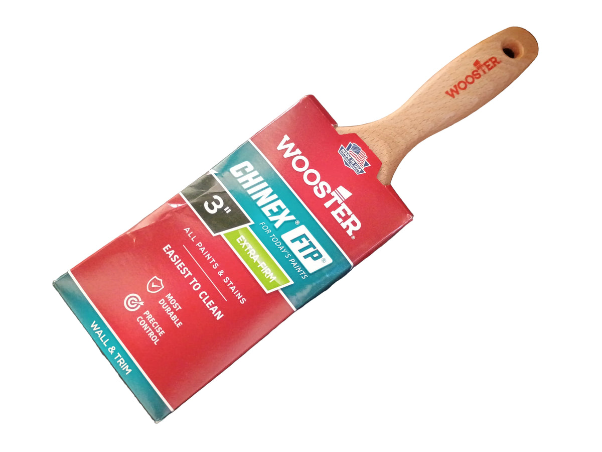 A Wooster Chinex FTP 3-inch paint brush with its retail packaging, placed diagonally on a white surface.