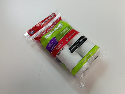 A package of two Wooster Jumbo koter 5/16" NAP, 4.5" roller covers, featuring white foam-covered rollers inside a clear plastic bag with a colorful red, green, and purple label.