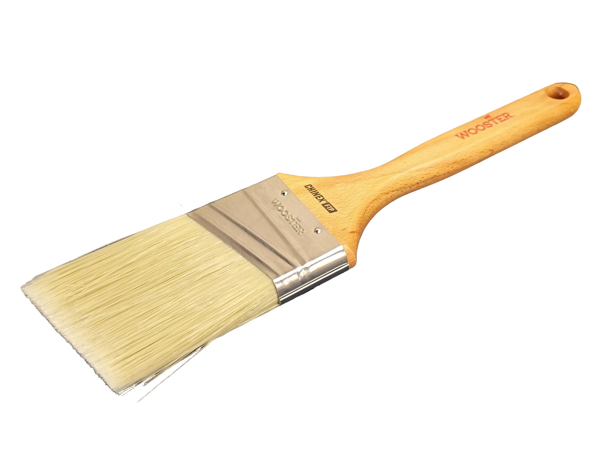 A wide flat paint brush with natural bristles, a silver metal ferrule, and a light wood handle printed with the WOOSTER brand name, with a white background.