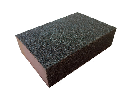A rectangular black abrasive sanding or grinding sponge block with a white background.
