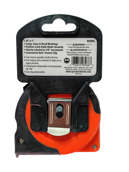 A pocket clip tape measure with a black plastic casing, bright orange inner clip housing, and a silver metal clip. The back cover is showing a white product information label with text and a barcode.