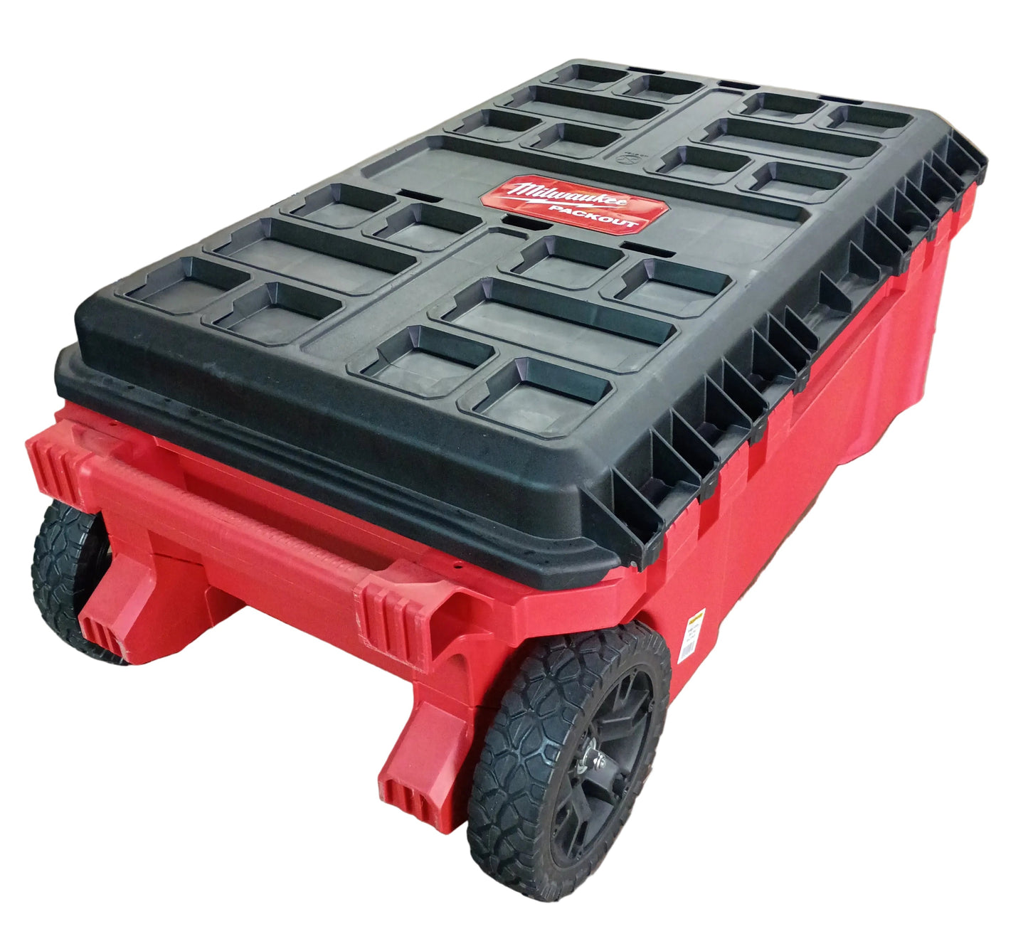 A red and black Milwaukee rolling tool box with a heavy-duty black lid and rugged black wheels, shown on a white background.