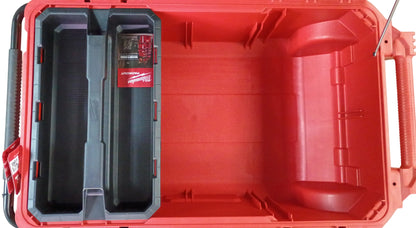 Top-down view of a red and black Milwaukee rolling tool box with an open lid, showing a molded interior organizer tray and a Milwaukee product card, on a white background.