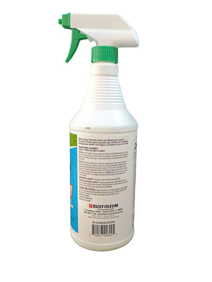 A white plastic spray bottle with a green trigger sprayer and green cap, showing the back label of a Rust-Oleum mean green mildew destroyer, set against a white background.